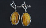 Stunning jewelry earrings and ring honey amber oval gemstones. Handcrafted artisan design jewelry with amber gemstones and unique ornament around jewelry. One of a kind jewelry from Armenian artisans and jewelry makers.