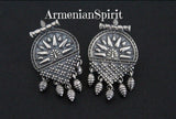 Our store offers a wide selection of earrings without stones made of silver in the ethnic, national Armenian Taraz style. These earrings have an unusual shape. They are small with an English lock, fit snugly to the earlobe and are comfortable all day long. The earrings have traditional Armenian patterns and small dangling neat details.