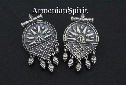 Our store offers a wide selection of earrings without stones made of silver in the ethnic, national Armenian Taraz style. These earrings have an unusual shape. They are small with an English lock, fit snugly to the earlobe and are comfortable all day long. The earrings have traditional Armenian patterns and small dangling neat details.