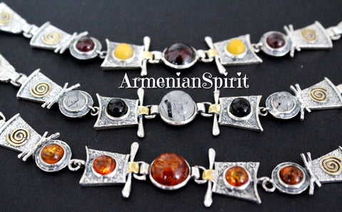 This handmade bracelet is the perfect addition to any woman's jewelry collection. Made with high quality sterling silver and accented with gold plating, it features a variety of bright gemstones such as amber,  garnet, onyx and venus hair quartz 
 that add a pop of color to any outfit. Each piece is stamped with 925, guaranteeing its quality. Elevate your style with this stunning piece.
