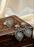 Armenian cross handmade Silver earrings and ring on a wooden jewelry box with decorative patterns.