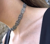 Close-up of a silver Armenian handmade filigree floral snug choker made from high quality sterling silver 925 on a person's neck.
