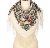 A classy merino wool palantine featuring vibrant orange, red, and blue floral motifs on a woman.