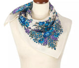 Floral blue and ivory Slavic patterned merino wool scarf on a mannequin with a white background