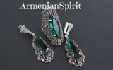 Jewelry set consisting of long shoulder earrings and long ring in Victorian old style with marcasite and emerald stone on a black surface with Armenian Spirit brand title.