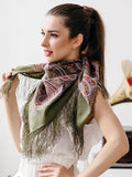 Buy an elegant woolen shawl in khaki and beige with fringe. Worn by a woman, it provides cozy warmth without itching.