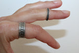 Two knuckle rings on a woman hand made of silver 25 and Armenian floral ornaments in traditional style.