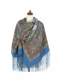 Paisley patterned scarf with silky  fringes on a mannequin against a white background