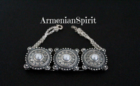 This traditional Armenian inspired bracelet features large details and chunky design, handmade with high quality sterling silver 925. Adorned with pearls, it adds a touch of elegance to any outfit. Perfect for those wanting to embrace their Armenian heritage or appreciate Western Armenian jewelry.
