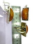 This stunning jewelry set features a large honey amber stone set in high-quality sterling silver (925). The rectangular ring and earrings are exquisitely crafted by Armenian artisans, resulting in a one-of-a-kind, unique piece. Elevate your style with this beautiful and rare jewelry set.
