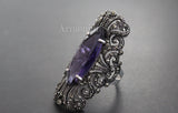 Luxury ring with marcasite and long purple gemstone.