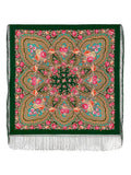 Decorative green scarf with pink  floral patterns and fringes on a green background.