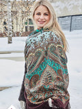 A woman wearing this brown shawl with bright turquoise ethnic ornaments looks effortlessly boho and elegant. The colors are rich and eye-catching, and the traditional folk design gives it a timeless feel. Warm, soft, and easy to style.