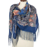 Blue peony floral and paisley cashmere like merino wool scarf with fringe on a mannequin against a white background