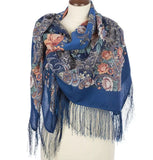 Blue peony floral and paisley scarf with fringe on a mannequin against a white background