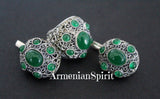 A pair of dome-shaped silver earrings with green quartz stones, handcrafted with marcasite details, displayed against a black background with the text 'ArmenianSpirit'.