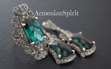 Luxury jewelry set consisting of earrings and ring in a large size with marcasite and faceted green transparent gemstone on a black background with Armenian Spirit title.