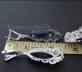 Long silver earrings with purple transparent stone and marcasite with English lock near a yellow ruler showing the length 2 inch with Armenian Spirit online store title.