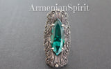 Emerald green marcasite ring luxury in a medieval style on a black surface with Armenian Spirit title.