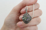Small pendant with chain and marcasite. The stone is rainbow opaz.