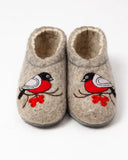 Pair of Slavic woolen bootie slippers with bullfinch bird and rowan berry design on a white background