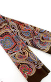 Colorful paisley-patterned brown women`s merino wool scarf colorful ornaments with Indian mandala on a white background
