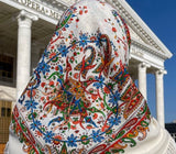 Colorful Slavic merino wool headscarf in front of an opera house.