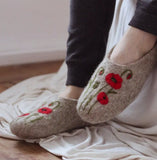Slippers woolen with floral design worn indoors on a soft surface