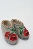 Pair of felted natural merino wool slippers with red poppies floral embroidery on a white background