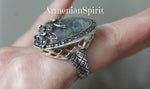 Indulge in this vintage Moss Agate ring, featuring a rare large oval cabochon gemstone in a gorgeous green hue. Crafted by skilled artisans in Armenia, this handmade ring is made of genuine Sterling Silver and adorned with delicate Marcasite flowers. A must-have for any jewelry lover and a retro addition to any collection.
