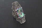 Mystic topaz large ring with marcasite and square stone on a black surfae