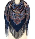 Paisley patterned navy blue woolen scarf with fringes on a mannequin against a white background