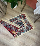 Decorative Armenian ethnic rug with geometric pattern on a wooden floor.