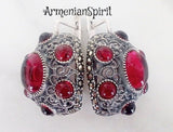 Large oval filigree earrings with English lock and red oval and round stones.