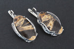 Expertly handcrafted with high-quality coconut jasper in stunning striped shades of caramel yellow and brown, this one-of-a-kind Armenian jewelry piece is truly a work of art. The vintage-inspired minimalist design is elevated by the lustrous sterling silver oval, making it a unique and timeless addition to any collection.
