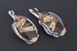 Expertly handcrafted with high-quality coconut jasper in stunning striped shades of caramel yellow and brown, this one-of-a-kind Armenian jewelry piece is truly a work of art. The vintage-inspired minimalist design is elevated by the lustrous sterling silver oval, making it a unique and timeless addition to any collection.
