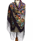 Colorful vintage floral-patterned merino wool like cashmere scarf with fringe in black and purple rich colors on a mannequin against a white background