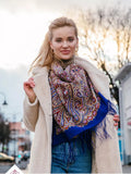 Wrapping shawl in blue with red and beige herbal pattern. 