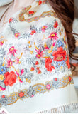 Close-up of a floral patterned Slavic shawl with intricate red rose designs.