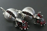 Armenian one of a kind silver earrings in a shape of big pomegranate with red gemstones on a dark background