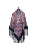 Decorative large shawl with floral patterns and fringes on a white background