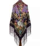 Colorful vintage floral-patterned shawl with fringe in black and purple colors on a white background