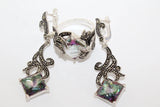 Pair of earrings with intricate designs and colorful gemstones on a white background