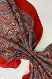 Red Slavic shawl with intricate paisley pattern on a white background