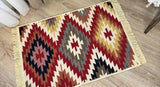 Decorative Armenian taraz ornament rug with geometric pattern on a wooden floor