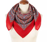 Red woolen Slavic scarf with a paisley pattern draped over a mannequin on a white background