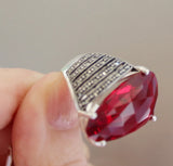 Exude vintage charm and elegance with our handmade Armenian jewelry. Crafted from high-quality sterling silver, this large ring features marcasites and a stunning red transparent stone. Inspired by 19th century designs, this piece adds a touch of history to your wardrobe. Upgrade your style with our exquisite jewelry.

