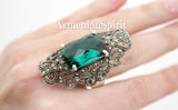 Luxury Tudor-style cosplay jewelry ring in 925 sterling silver with vibrant green emerald faceted stones and glittering marcasites on a woman finger with Armenian Spirit title.