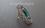 Luxury very long ring with marcasite and emerald green gemstone on a black surface with Armenian Spirit title.