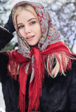 Woman wearing a red and patterned scarf outdoors with snow in the background
